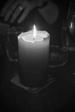 A single candle in grayscale Foto stock