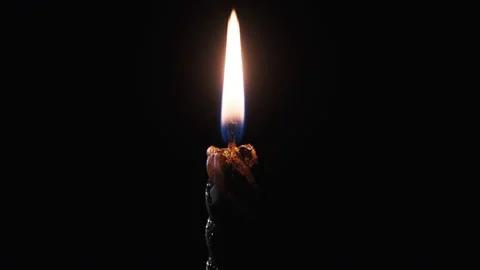 A Single Candle is Lit on a Black Background. Candle Flame in the Dark. Stock Footage 142273455