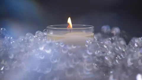 Single Candle Lit with rotating Lens Flare. Christmas Video stock 128816677