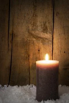 Single candle with snow Stockfoto's