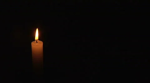 Single Candle Vigil Offset on Black background Stock Footage
