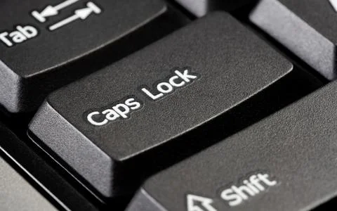 Single caps lock key on a simple black desktop PC computer keyboard, object Stock Photos