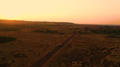 Single Car drives on an empty road during sunrise Video stock 149008798