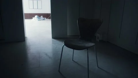A single chair left left in an abandoned warehouse Stockbeeldmateriaal 156897178