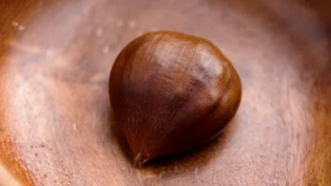 Single chestnut in rustic wooden bowl Stock Footage 296645798
