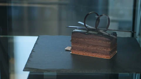Single chocolate cake in shop-window Stock Footage 121351762