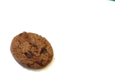 A Single Chocolate Chip Cookie on a White Background Displays Simple Sweetnes Stock Photos
