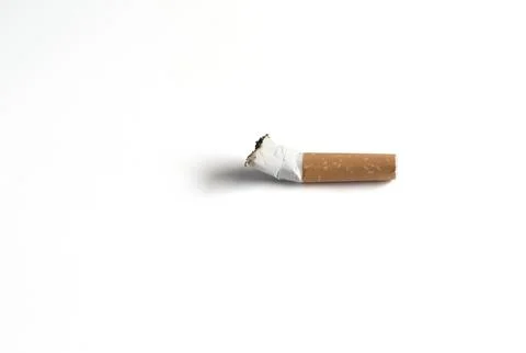 Single cigarette butt with ash isolated on white background Stock Photos