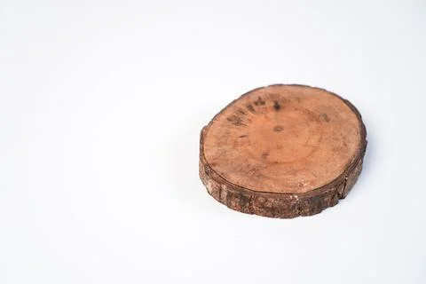 A single circular wooden log slice coaster placed on the right side of a pl.. Stock Photos