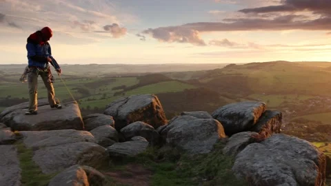 Single climber pulling up rope in the Peak District Derbyshire Stock Footage 169844487