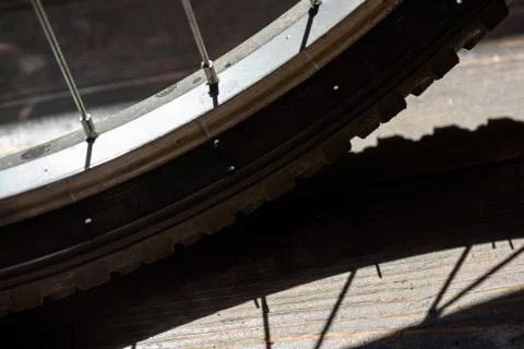 Single closeup macro image of a bikes rear wheel with spokes and tyre visible Stock Photos