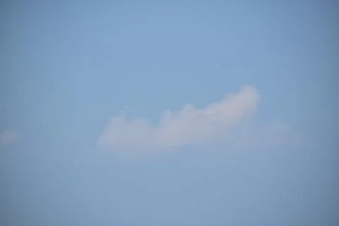 Single cloud in the blue sky. Stock Photos