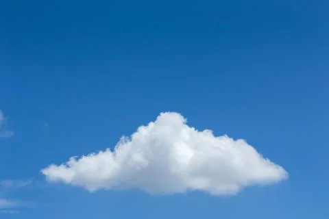 Single cloud on clear blue sky background Fotos Stock