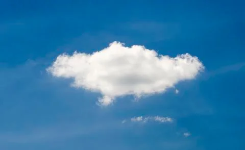 Single cloud in deep blue summer sky Stock Photos