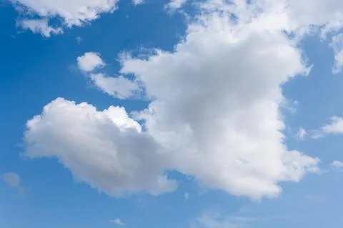 Single clouds in rural landscape in middle of lonely field summer season Фото