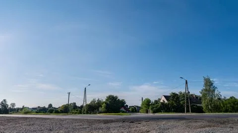 Single clouds in suburban landscape over a rural road Фото