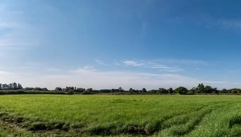 Single clouds in suburban landscape over a rural road Foto stock