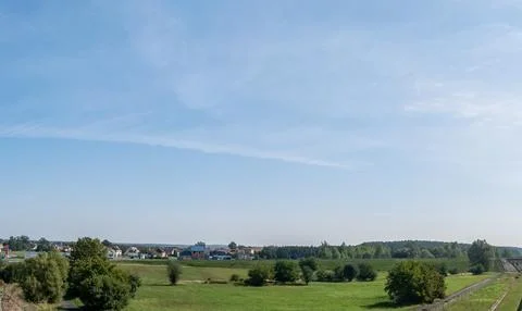 Single clouds in suburban landscape over a rural road Foto stock