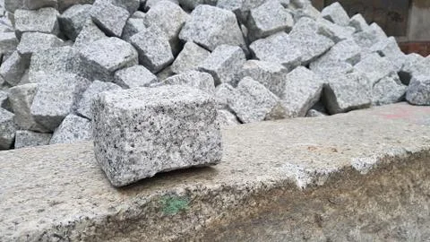 Single cobblestone in front of many others Stock Photos