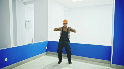 Single construction worker in room dancing fun Видео 68607348