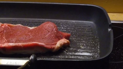 Single cooking a steak at home Stock Footage 77479225