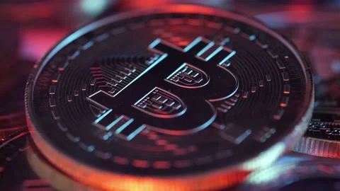 Single Crypto Currency Bitcoin Rotating Under Colorful Lights. Stock Footage 147559295