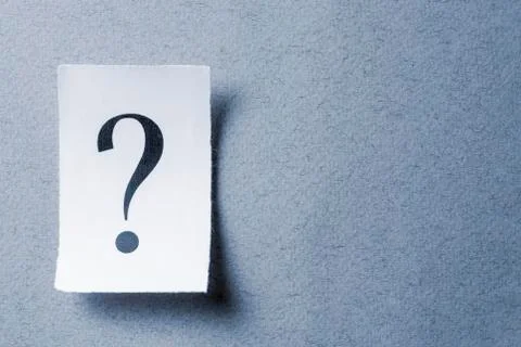 Single curled card with printed question mark Foto stock