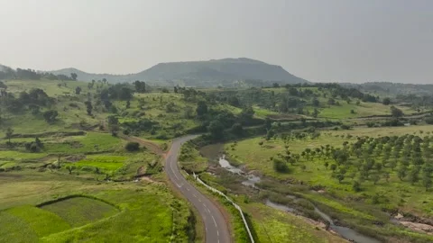 Single cyclist ride bicycle on road in nature surrounded by mountains green.. Stock Footage 283984889