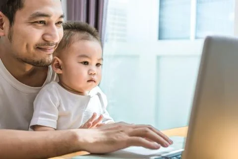 Single dad and son using laptop together happily. Technology and Lifestyles c 写真素材