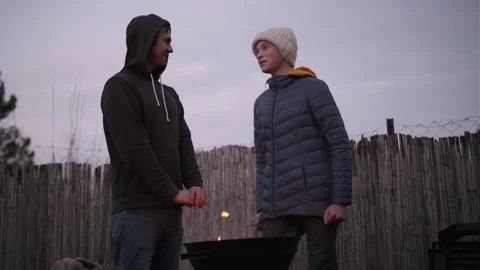 Single dad and two sons. Barbecue fire in backyard, cozy evening Stock Footage 336561106