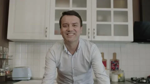 Single dad smiling at camera in the kitchen of his house. Stock Footage 201338401