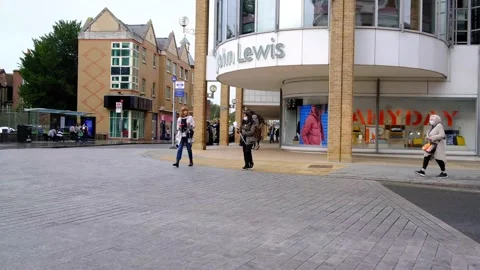 Single Deck Red Bus Passing A Modern John Lewis And Waitrose Department Store Stock Footage 162612223