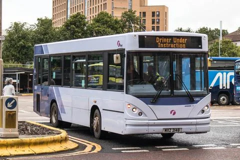 Single decker bus with Driver Under Instruction learning to drive Stock Photos