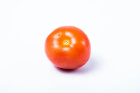 Single delicious red tomato without stalk. Isolated on white background Stock Photos