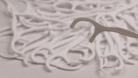 Single dental floss pick, rotation in circle. one floss tool above rotating Stock Footage 323331529