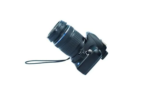 Single digital camera of black color with lens attached to it placed on a whi Stock Photos