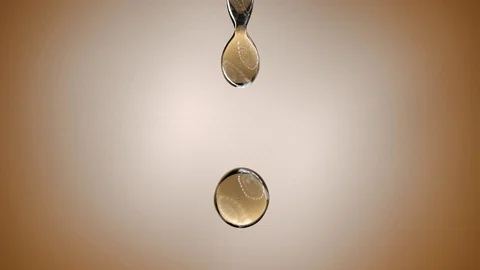 A single droplet of oil falling. 4K. ultra Slow Motion. Stock Footage 86574033