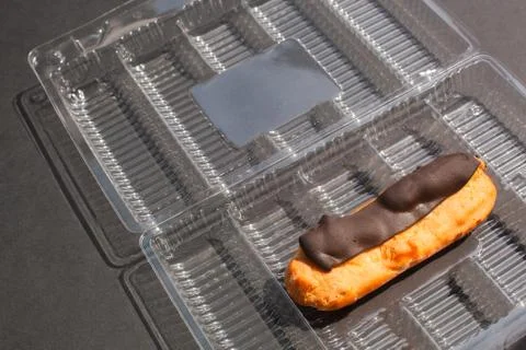 Single Eclair cake with scalded chocolate and coffee butter cream in standard Stock Photos