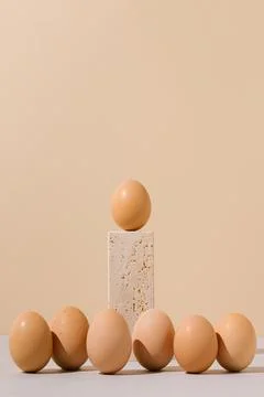 Single egg standing on a travertine marble block podium. Stock Photos