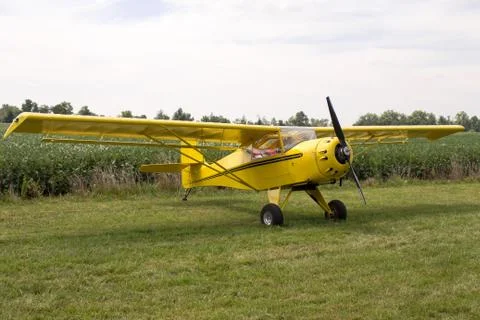 Single engine aeroplane parked on grass Stock Photos