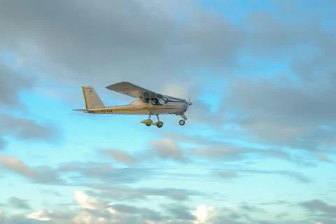 Single engine aircraft in cloudy sky Stock Photos