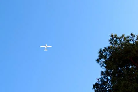 Single engine aircraft high in the blue sky Stock Photos