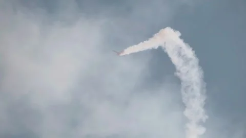 A single-engine airplane does incredible stunts in the blue sky Stock Footage 242792981