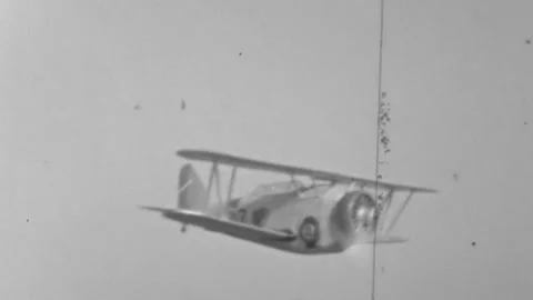 A single-engine biplane with an enclosed canopy and radial engine flying Stock Footage 341373023
