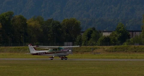 Single-engine, high wing aircraft Cessna 172N Skyhawk II vacating the runway Stock Footage 221274736