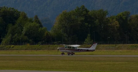 Single-engine, high wing aircraft Cessna 172N Skyhawk II vacating the runway Stock Footage 221274796