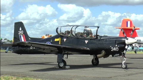 Single Engine Plane with Pilots in Cockpit Parked on Airstrip Stock Footage 75690328