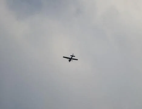 Single engine plane surrounded by gloomy clouds illustrates moodiness and a.. Фото
