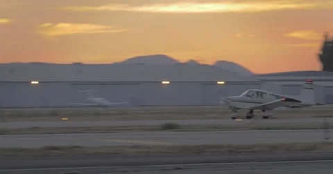 Single engine plane take off at sunset Stock Footage 40751081