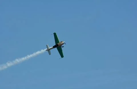 Single-engine propeller airplane doing a steep acrobatic Stock Photos